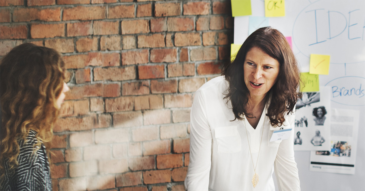 Facilitator of a meeting speaking to a participant